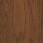 Close-up of brown wood grain texture, likely a tabletop or panel surface.